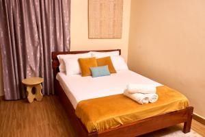 a bedroom with a bed with towels on it at Oasis Guesthouse Juba in Juba