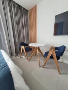 a living room with a table and two chairs at Porto Horizonte suite 424 in Playa Bello Horizonte