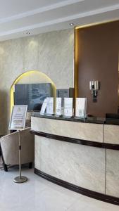 a lobby with a counter with signs on it at وادي برزان للشقق المخدومة in Hail