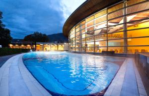 a large swimming pool in front of a building at Praterhof Chalet in Südtirol - Natur, Ruhe & Bergblick in Bressanone