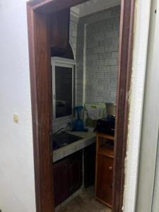 a kitchen with a sink and a mirror at Eilena prestige in Douala