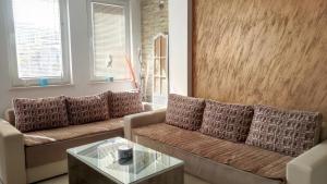 a living room with two couches and a glass table at Apartment Nika in Ohrid