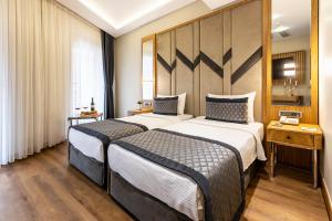 a hotel room with two beds in a room at Sultanahmet Newport Hotel in Istanbul