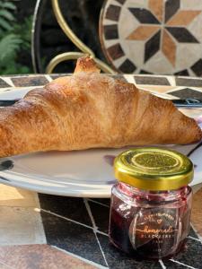 a plate with a loaf of bread and a jar of jam at Flemish House in Beccles