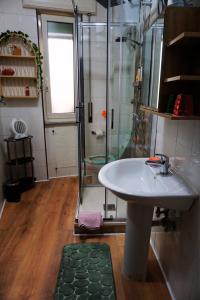 a bathroom with a shower and a white sink at Nice room with private bathroom in Ercolano +13 photos