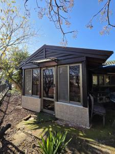 a screened in porch of a house at Among the cherry trees B&B 6 - Nahal Dan in Metulla