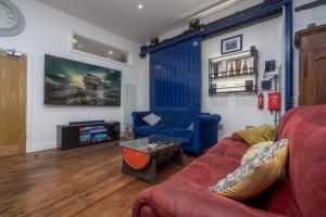 a living room with a couch and a tv at Luxury Barbican Apartment in Plymouth