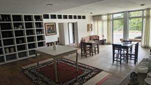 a living room with a table and some chairs at Casa Caminho do Meio in Rio de Janeiro