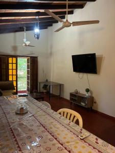 a living room with a table and a flat screen tv at Villa Morra House l in Asunción