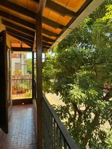 a porch of a house with a tree at Villa Morra House l in Asunción