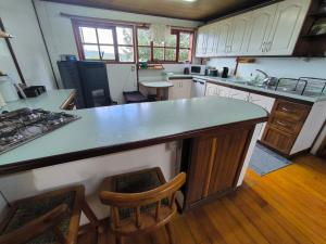 a kitchen with a large island in the middle at Casa de la bahia de Chiloé in Castro