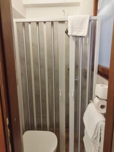 a bathroom with a shower with a toilet and towels at Alloggi Acquavita - checkin at "Alloggi SS Giovanni e Paolo" in Venice