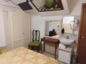 a bathroom with a bed and a sink and a mirror at Alloggi Acquavita - checkin at "Alloggi SS Giovanni e Paolo" in Venice