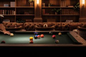 a man playing pool in a billiard room at Villa Foresta in Lidingö