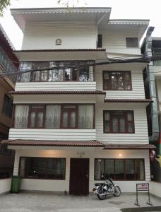 a motorcycle parked in front of a building at OS Hotel Pomra in Gangtok