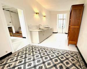 a kitchen with a black and white tile floor at Villa Paignon Gite in Montbron +32 photos