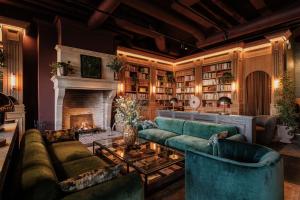 a living room with a couch and a fireplace at Villa Foresta in Lidingö +16 photos