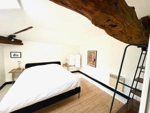 a bedroom with a bed and a staircase in it at Villa Paignon Gite in Montbron