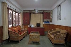 a living room with two chairs and a couch at OS Hotel Pomra in Gangtok