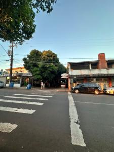 an empty street with cars parked in front of a building at Pousada Amizade in Água Boa