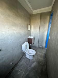 a bathroom with a white toilet in a room at Pousada Amizade in Água Boa