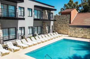 a swimming pool in front of a building at Palmas de la Laguna by Posada Suiza in San Miguel del Monte