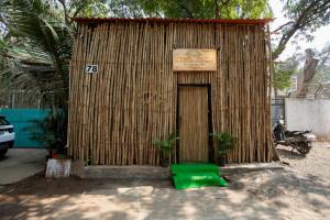 a small hut with a sign on top of it at De Classico Hotel Apartment in Mumbai