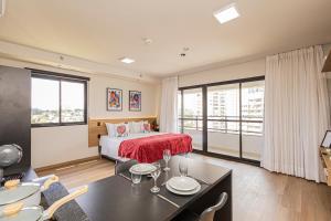 a bedroom with a bed and a table and chairs at Sky Design Residence in Barueri +28 photos