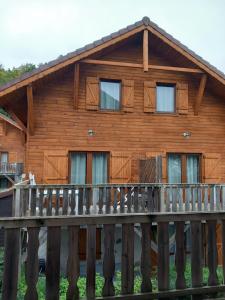 a log cabin with a wooden deck at Les chalets d Evian in Évian-les-Bains