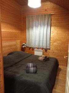 a bedroom with a large bed with a window at Les chalets d Evian in Évian-les-Bains