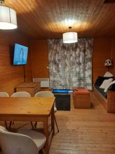 a room with a table and chairs and a bed at Les chalets d Evian in Évian-les-Bains