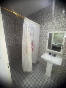a bathroom with a sink and a shower at Appartement privatif À Mbour face RN1 in Mbour +4 photos