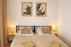 a bedroom with two beds and three pictures on the wall at Ferienwohnung Wie dehemm in Sankt Ingbert +8 photos