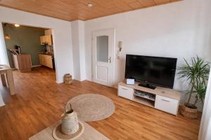 a living room with a flat screen tv on a entertainment center at Ferienwohnung Wie dehemm in Sankt Ingbert