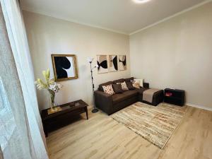 a living room with a couch and a table at Casa Acqua e Sale - 50 mt dal mare in Fano