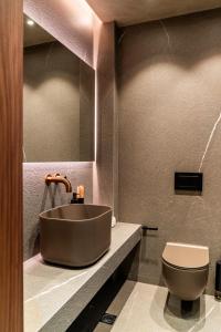 a bathroom with a sink and a toilet at Selemnos Boutique in Patra +26 photos