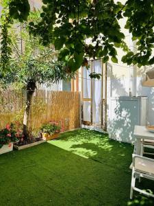a garden with a green lawn and a tree at Casa Acqua e Sale - 50 mt dal mare in Fano