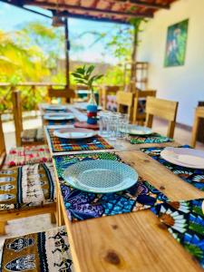 a wooden table with plates on top of it at Nilio Explorer & Lodge in Mfumbwi