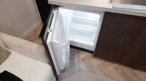 an empty refrigerator with its door open in a kitchen at Luxury Studio - Romainville in Romainville
