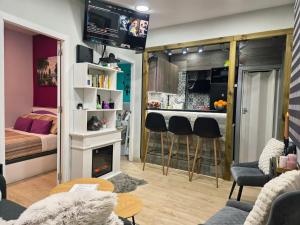 a living room with a bed and a kitchen with a fireplace at Casa Atocha 1913 Apartamento Histórico con Encanto in Madrid