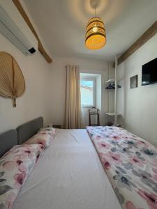 a bedroom with a large bed with a floral blanket at LevOasi 7 - Garden, jacuzzi and sauna escape in Levo