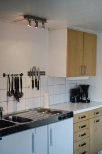 a kitchen with a sink and a stove top oven at GrebbestadFjorden stugor in Grebbestad +19 photos