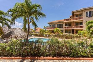 a resort with a swimming pool and palm trees at Palma Divine Condo-2BR-2BTH-Pool in Noord