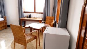 a small dining room with a table and chairs at Jamaica House in Nungwi