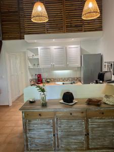 a kitchen with a wooden counter with two lights at Kouliwou in Saint-François
