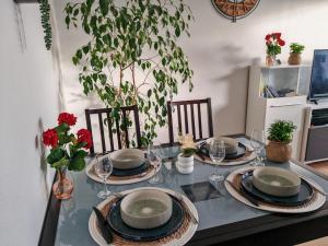 a dining room table with plates and glasses on it at Superbe cocon de 44m2 in Longvic
