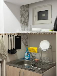 a kitchen counter with a sink in a kitchen at Cozy Grey Studio in Chişinău