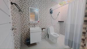 a bathroom with a toilet and a sink and a shower at Hotelru Koh Larn-โฮเต็ลรุ เกาะล้าน in Ko Lan +24 photos