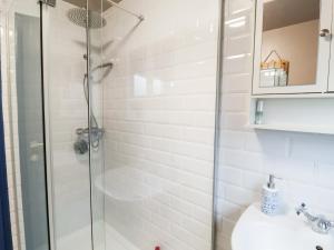 a bathroom with a shower and a toilet and a sink at Lilly Cottage in Woodbridge +11 photos