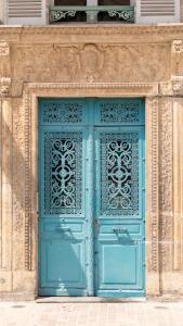 a blue door on a building with a window at La P'tite Maison D'Auron in Bourges